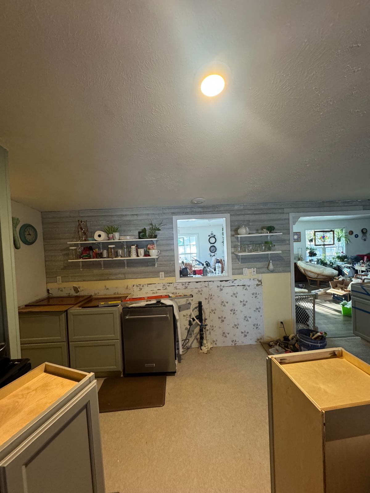 Kitchen renovation - New gray shaker cabinets and backsplash area with shiplap wall